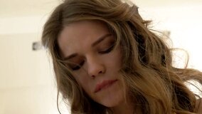 A perfect teen with a skinny body is naked on the bed, playing alone