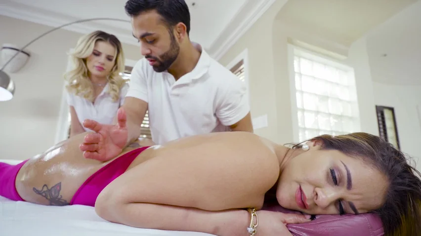 Two Blondes Are Together With A Man On The Massage Table